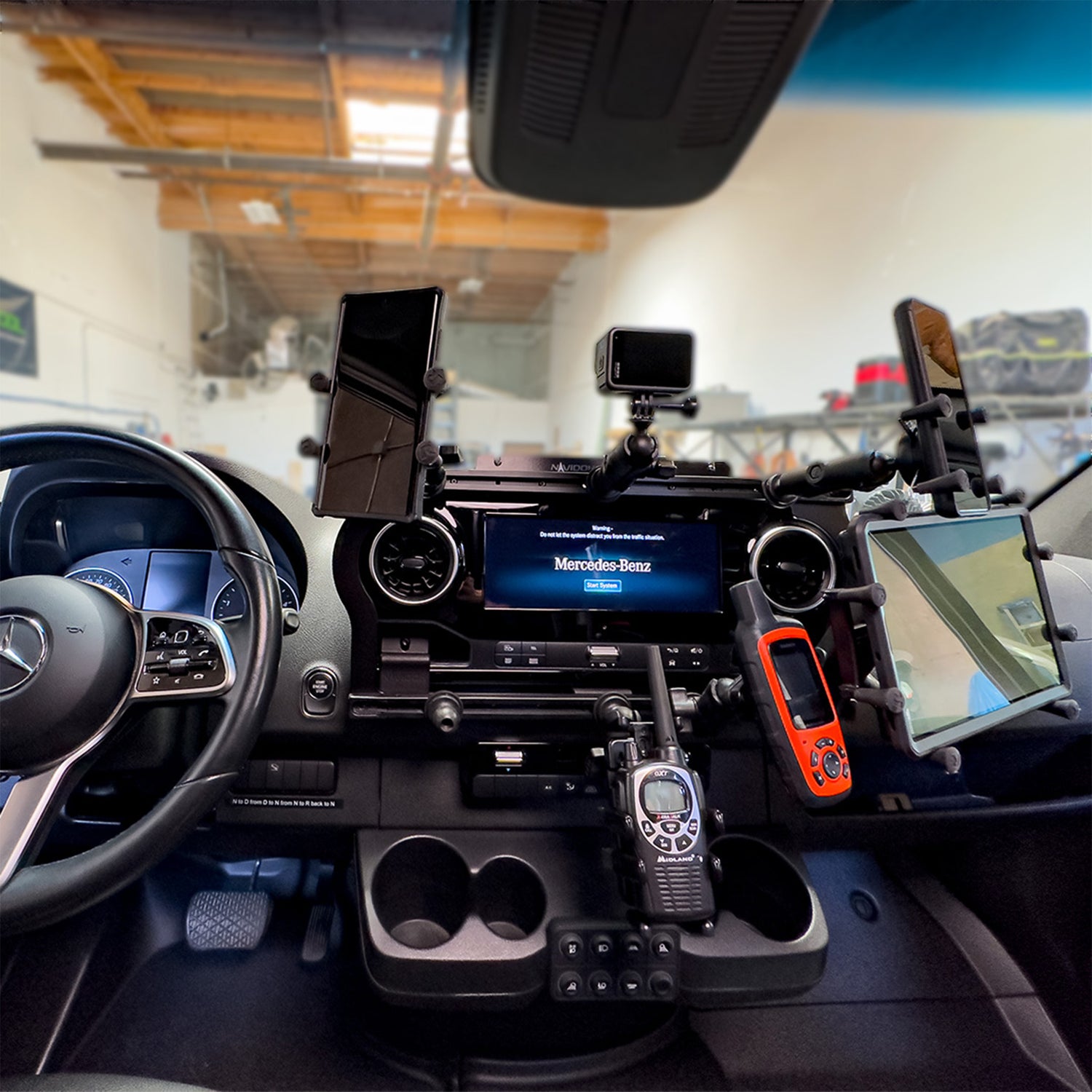 A close up of Terra X Navidok Overlander X and multiple phones and RAM Mounts and Ipad holders and Go Pro holder in a Mercedes Sprinter van