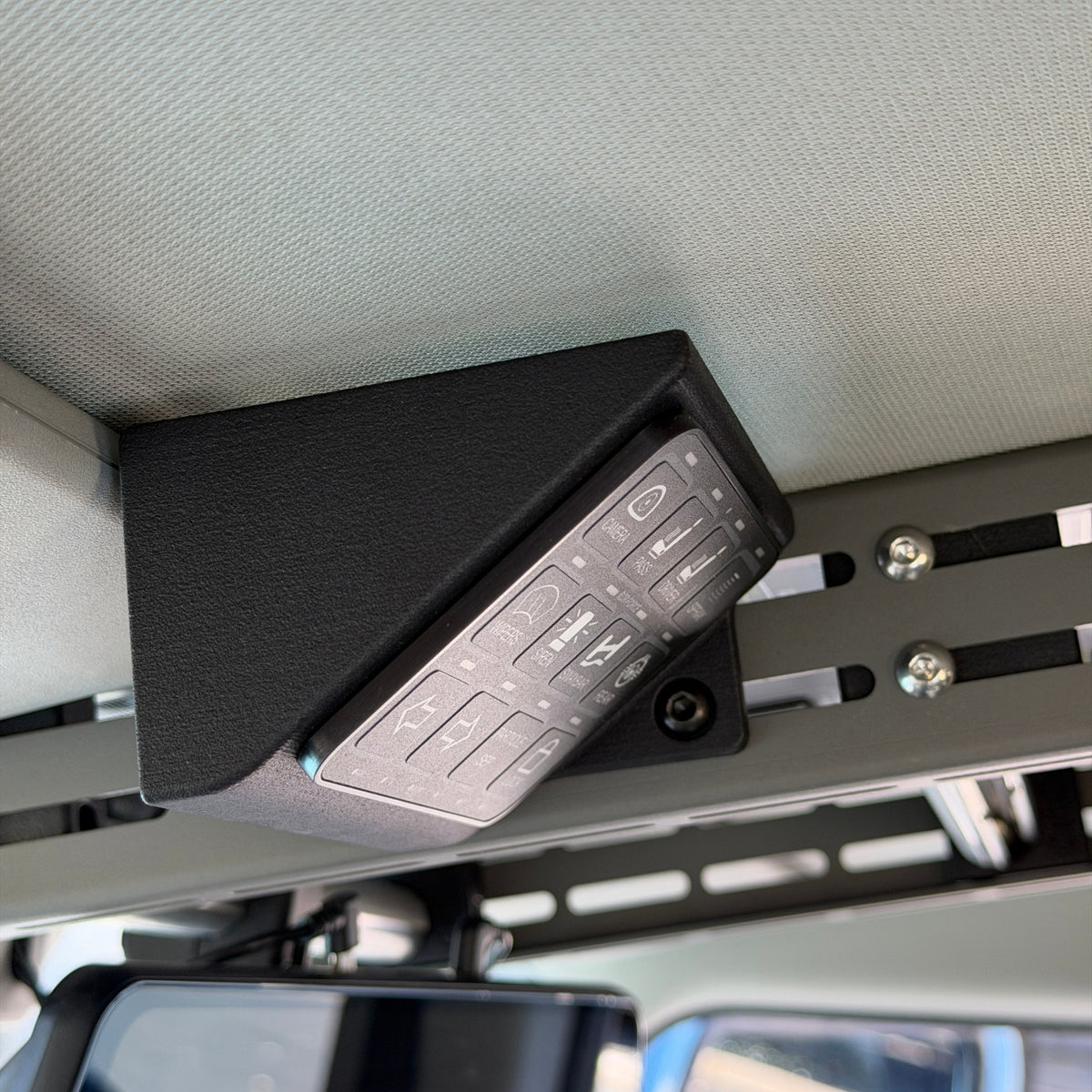 Cabdok Switch-Pros Mount holding a Switch-Pros 12 switch panel at an angle on the driver's side of the Cabdok