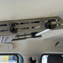 Close-up of the two black Nylon 12 Cabdok Fire Extinguisher Mount clips attached to the Cabdok side panel with bolts, with no extinguisher installed
