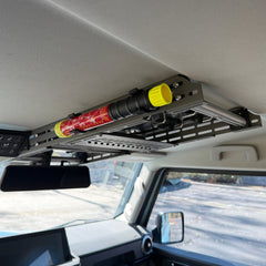 Element E50 fire extinguisher held in two black Nylon 12 clips on the side of the Cabdok in an Ineos Grenadier, seen from the front seat looking toward the rear