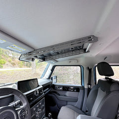 Cabdok overhead storage mount in Ineos Grenadier viewed from driver's seat, clear of dash controls and touchscreen