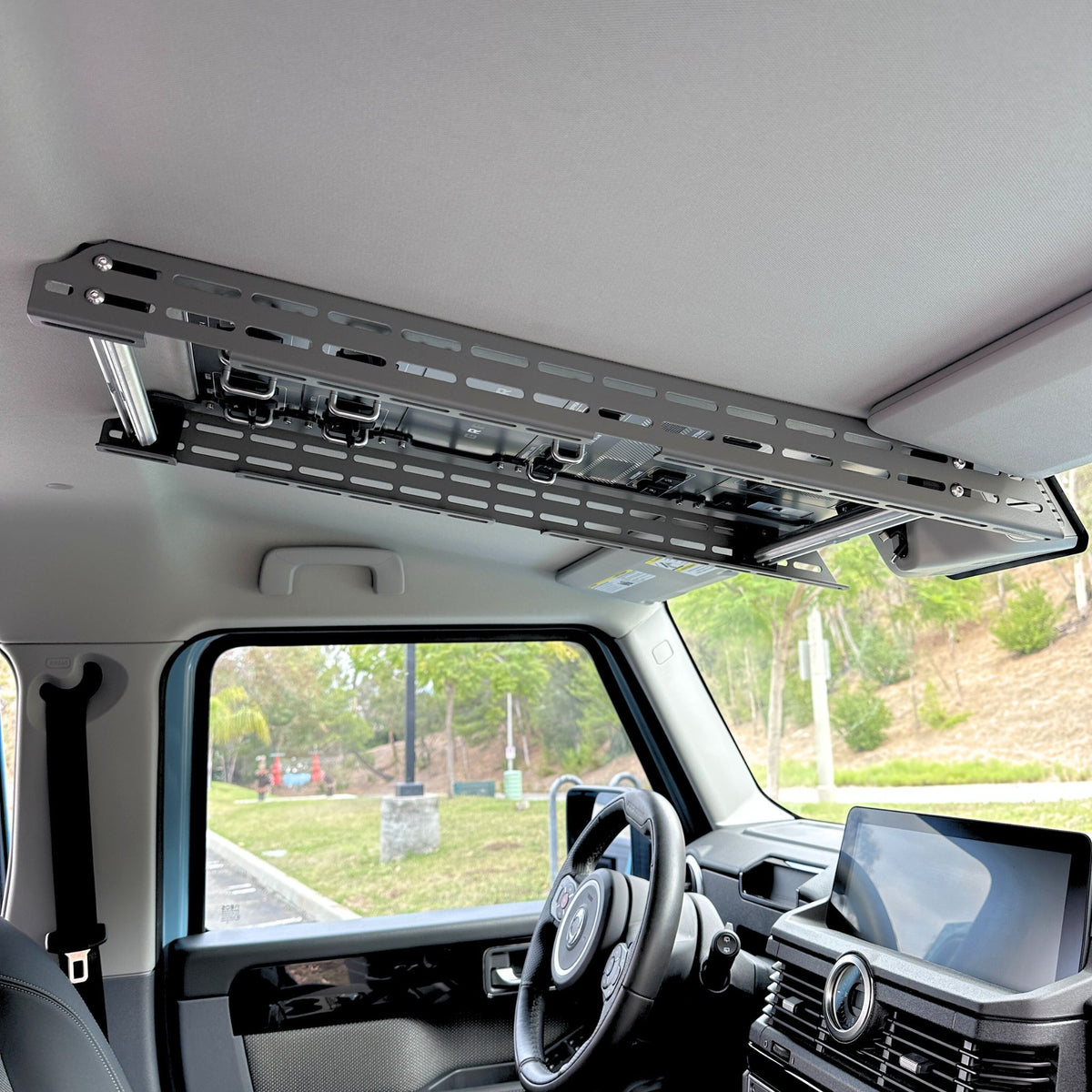 Cabdok overhead storage mount in Ineos Grenadier viewed from passenger side, clear of windshield and dash controls