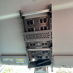 Wide shot, installed: Cabdok Molle Storage Panel mounted in full Ineos Grenadier overhead console with switch panels above and below